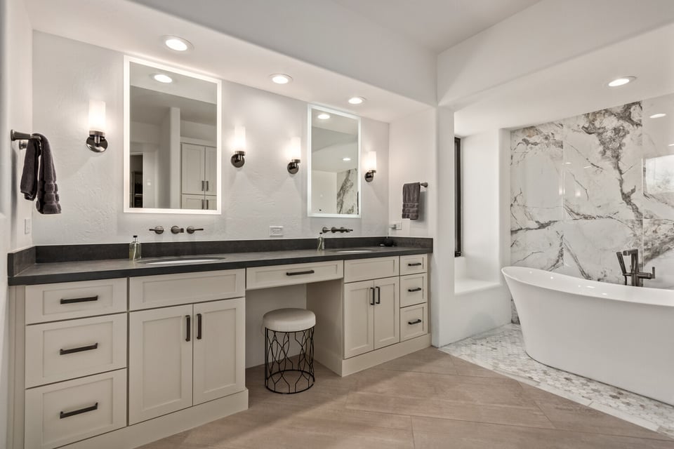 Elegant bathroom renovation in Phoenix, AZ with backlit mirrors and freestanding soaking tub by Kitchens by Good Guys