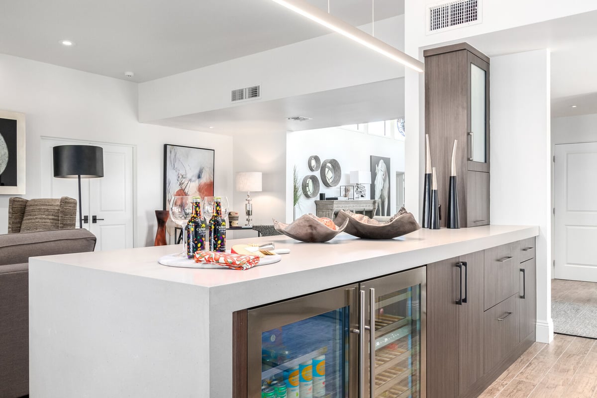 Close-up of bar counter with built-in wine cooler in Rio Verde, AZ custom home by Kitchens by Good Guys.