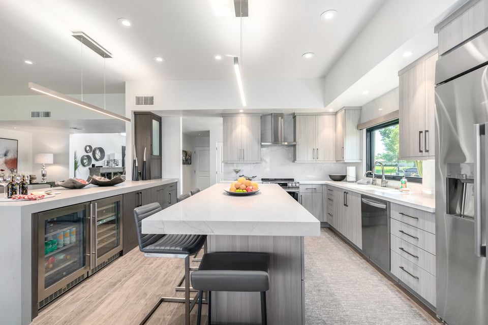 Contemporary kitchen featuring dual-tone cabinetry and modern lighting by Kitchens by Good Guys in Paradise Valley, AZ.