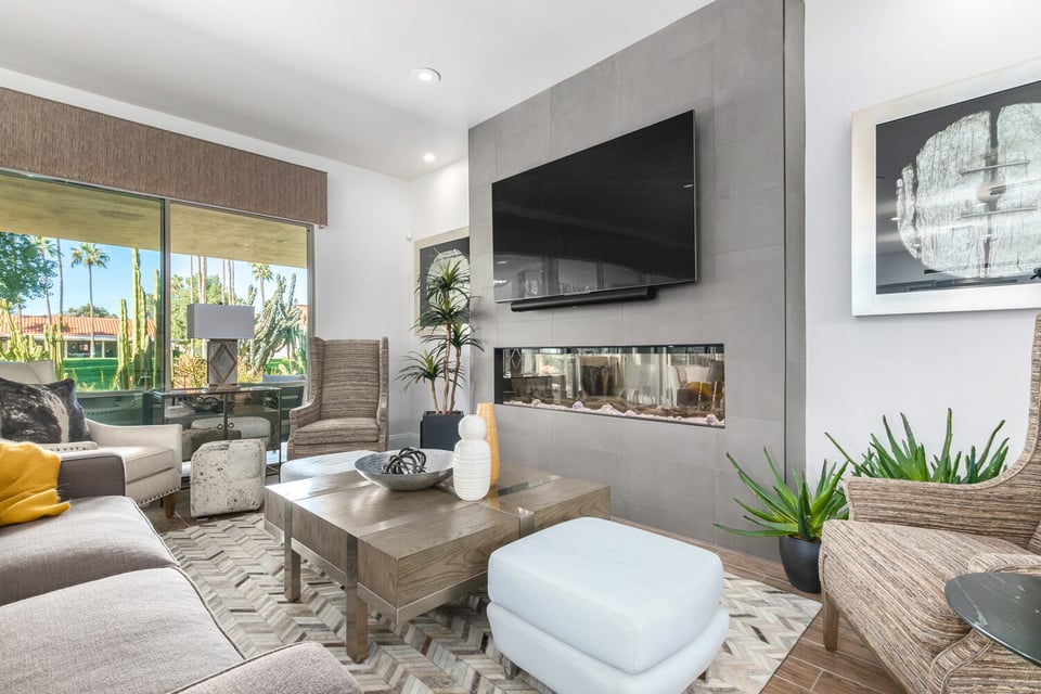 Contemporary living room in custom home by Kitchens by Good Guys in Scottsdale, AZ featuring a sleek fireplace and large window views.