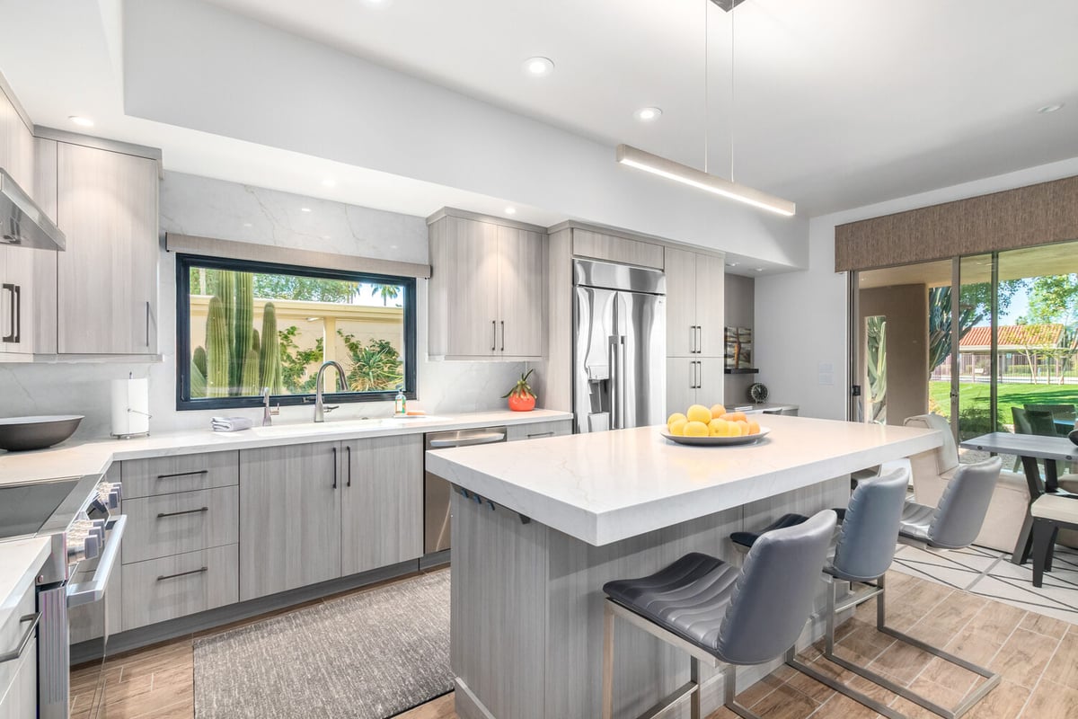Custom home kitchen design featuring sleek cabinetry and large windows by Kitchens by Good Guys in Phoenix, AZ.