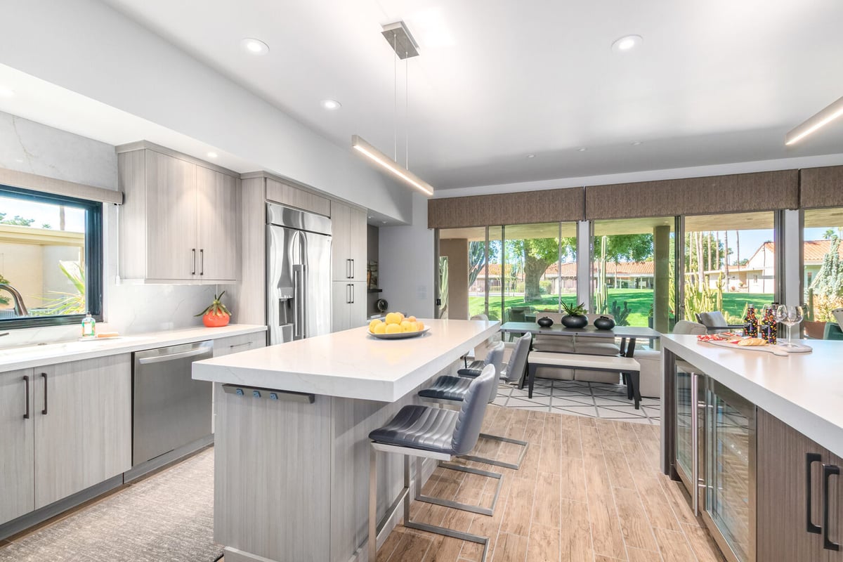 Kitchen island with seating and large window views in custom home by Kitchens by Good Guys in Rio Verde, AZ.
