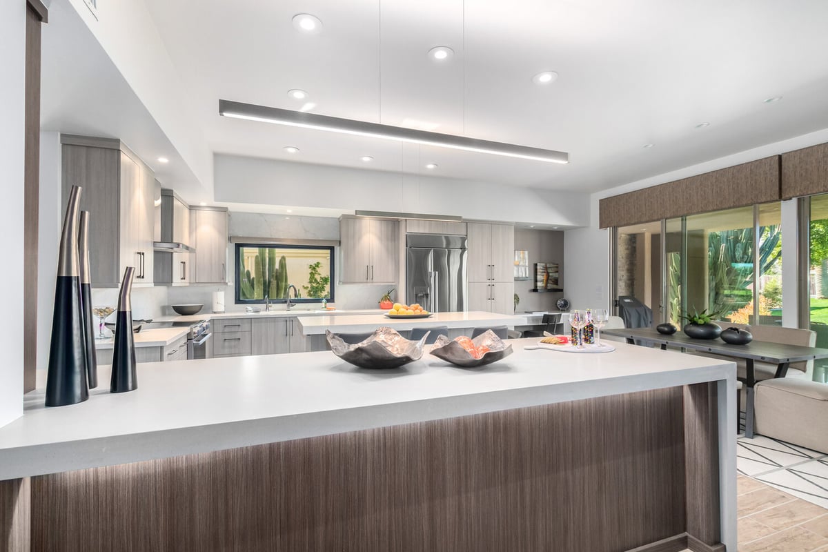 Modern kitchen layout with large island and dining space by Kitchens by Good Guys in Phoenix, AZ.