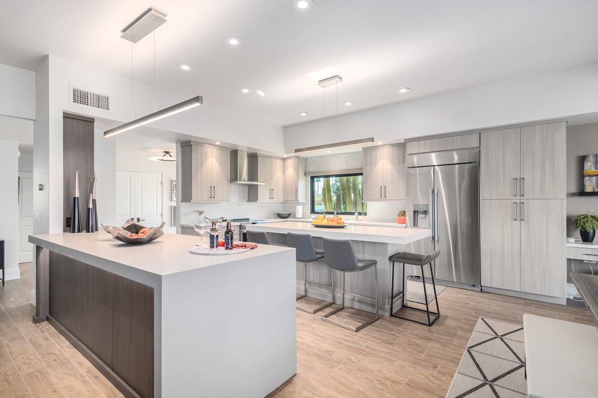 Spacious modern kitchen remodel by Kitchens by Good Guys in Phoenix, AZ with wood floors and large island.