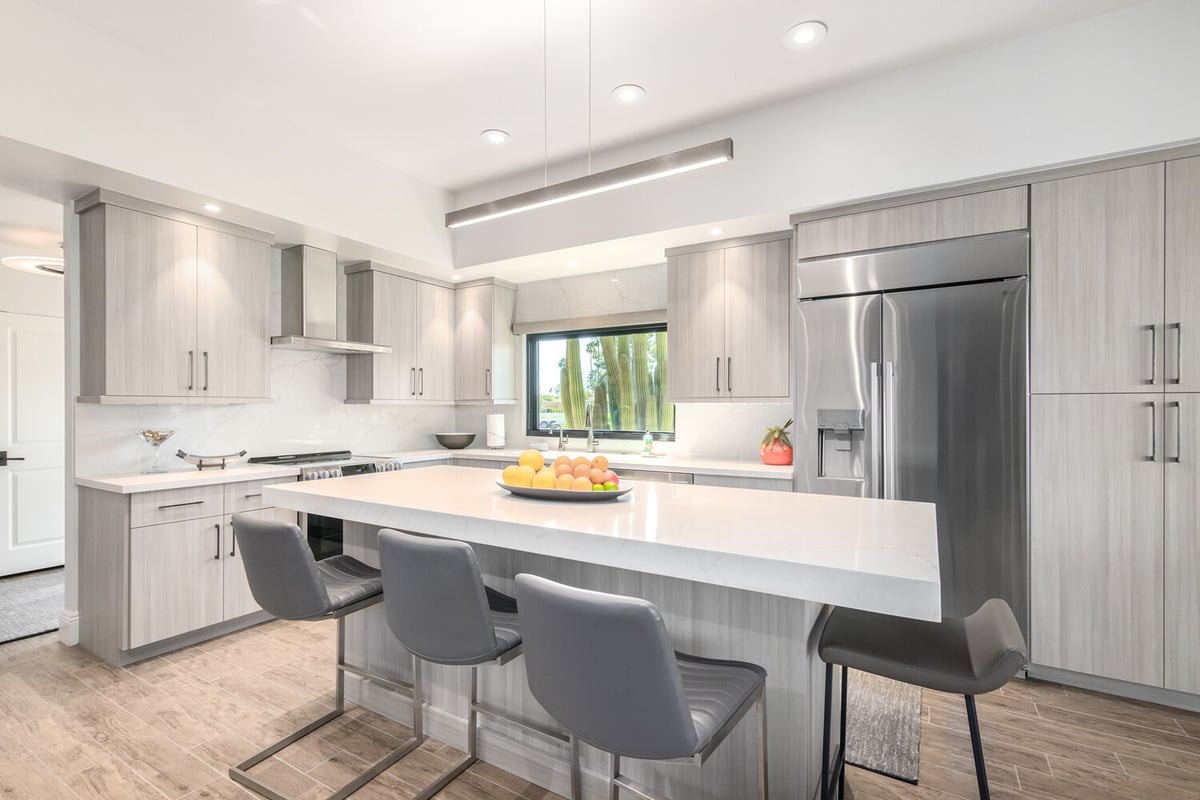 Stylish kitchen renovation featuring high-end cabinetry and bar stools by Kitchens by Good Guys in Phoenix, AZ.