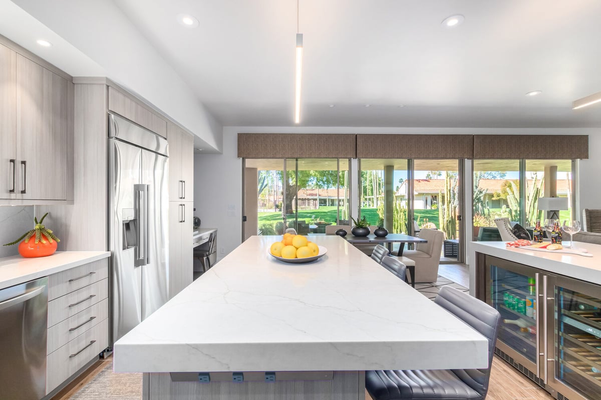 View of custom kitchen with island bar and expansive window lighting by Kitchens by Good Guys in Glendale, AZ.