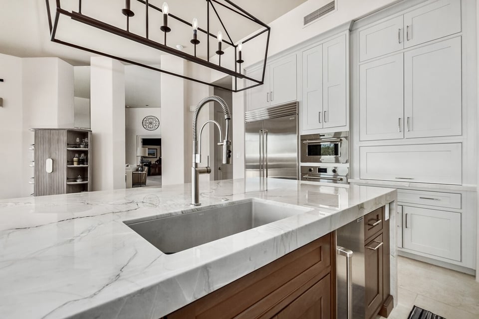 Close-up of marble island and prep sink in custom kitchen by Kitchens by Good Guys in Phoenix, AZ.