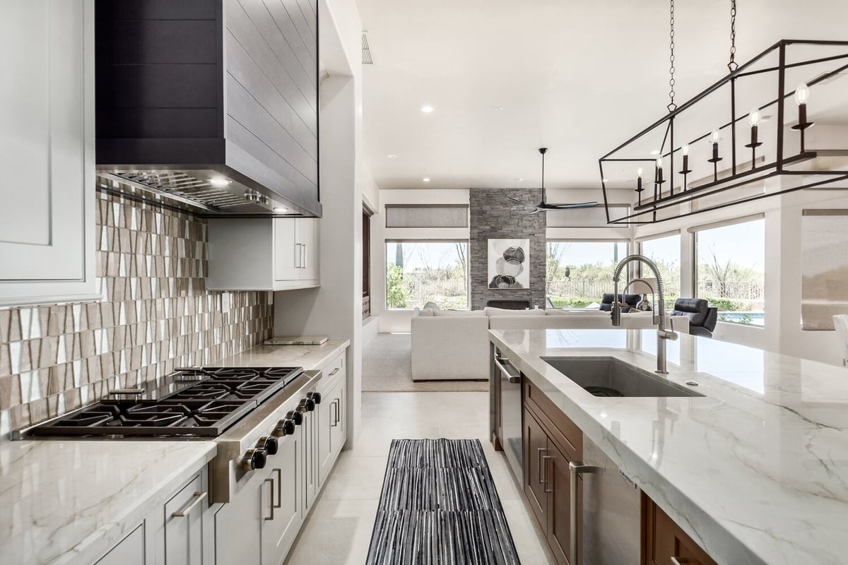 Contemporary kitchen with large island and designer tile backsplash by Kitchens by Good Guys in Phoenix, AZ.