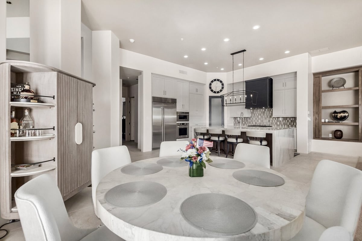 Dining space overlooking gourmet kitchen with marble table by Kitchens by Good Guys in Scottsdale, AZ.