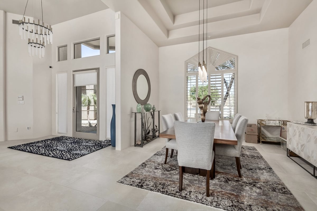 Formal dining room with tray ceiling and sculptural lighting by Kitchens by Good Guys in Fountain Hills, AZ.