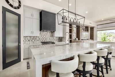 Gourmet kitchen with marble island and panoramic windows by Kitchens by Good Guys in Phoenix, AZ.