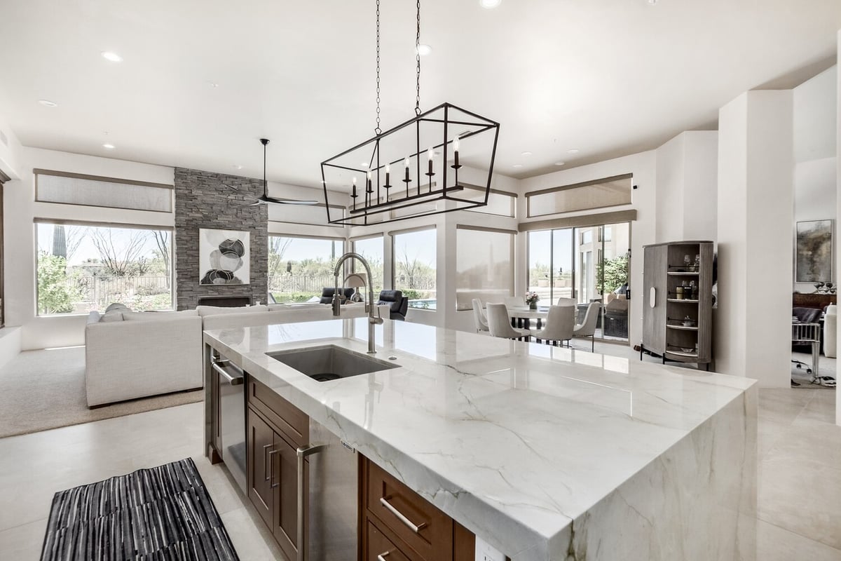 Open kitchen layout with pendant chandelier in custom Arizona home by Kitchens by Good Guys.
