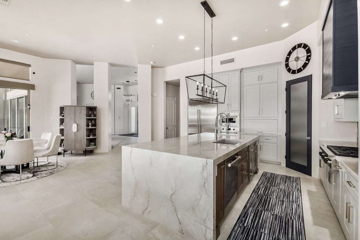 Refined kitchen design with high-end finishes and center island in a Scottsdale home by Kitchens by Good Guys.