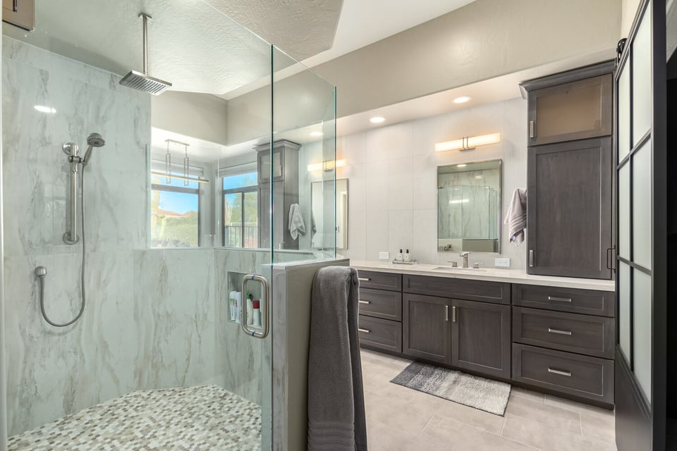 Bathroom remodel with glass shower enclosure and dual vanities by Kitchens by Good Guys in Scottsdale, AZ.