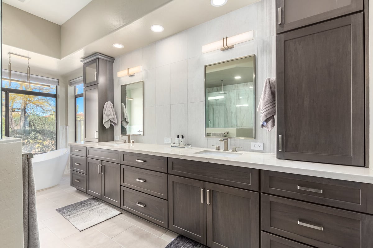 Custom bathroom vanity with double sinks and soft lighting by Kitchens by Good Guys in Scottsdale, AZ.