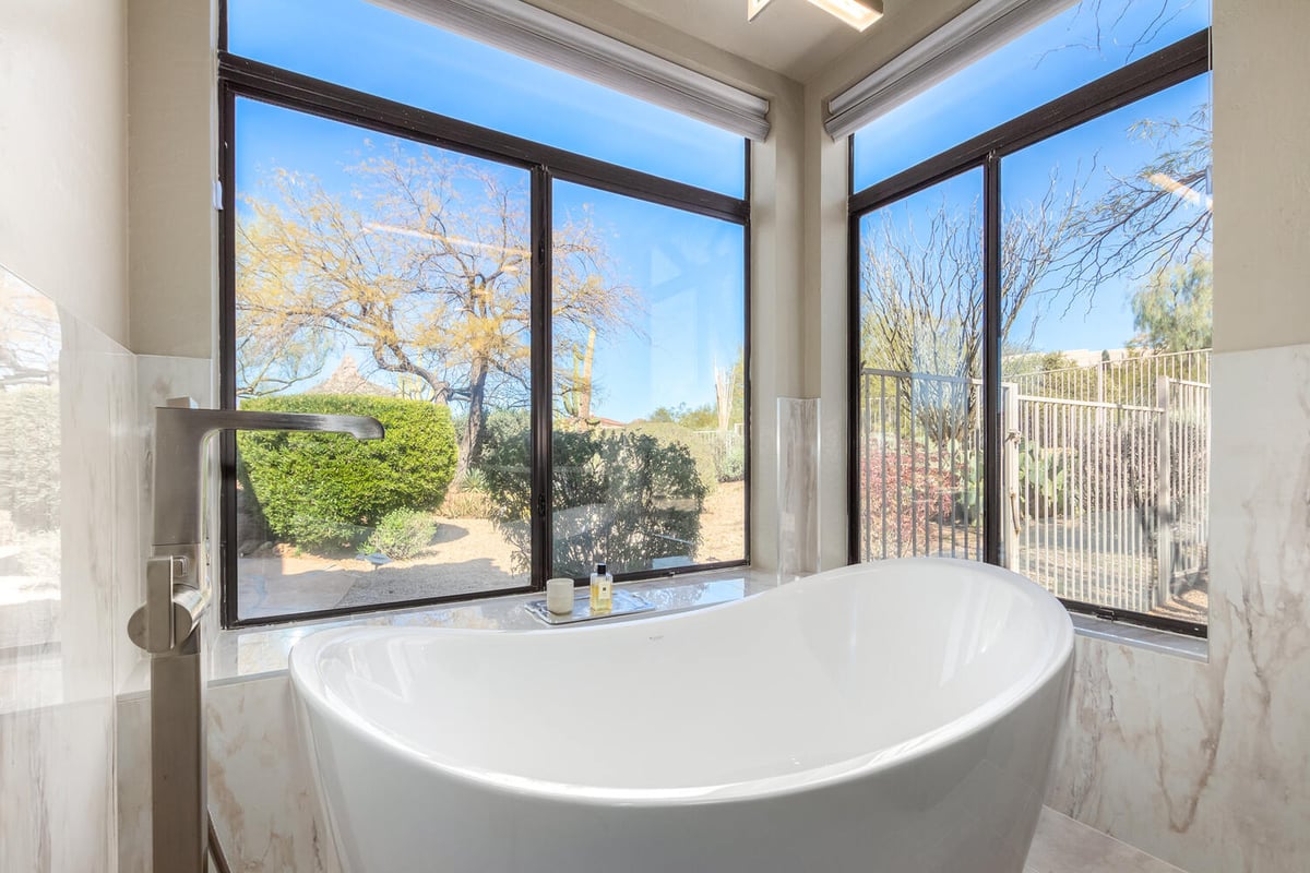 Freestanding tub with large picture windows and scenic views by Kitchens by Good Guys in Rio Verde, AZ.