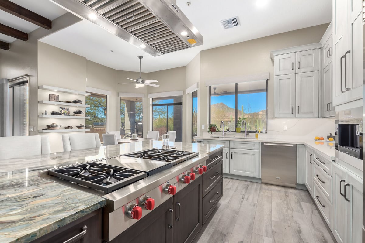 Gourmet kitchen with expansive island and dual ovens in Paradise Valley, AZ by Kitchens by Good Guys.