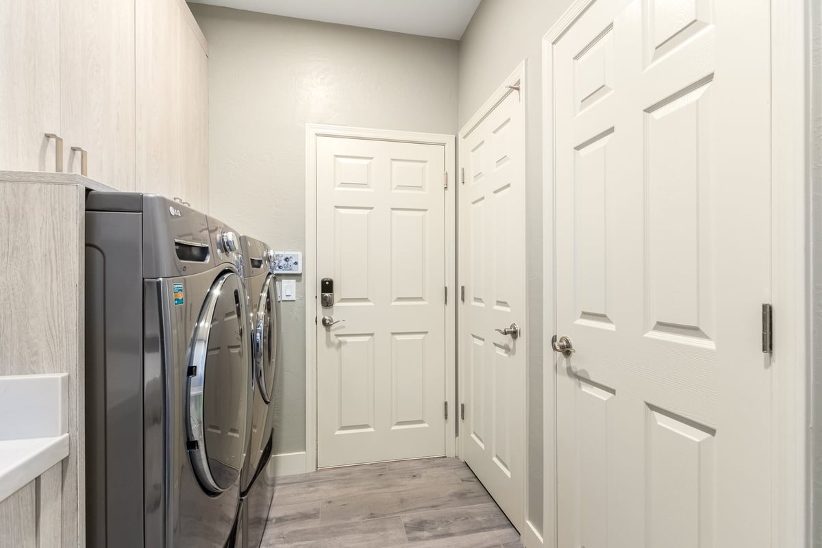 Laundry room entrance area with modern appliances by Kitchens by Good Guys in Glendale, AZ.