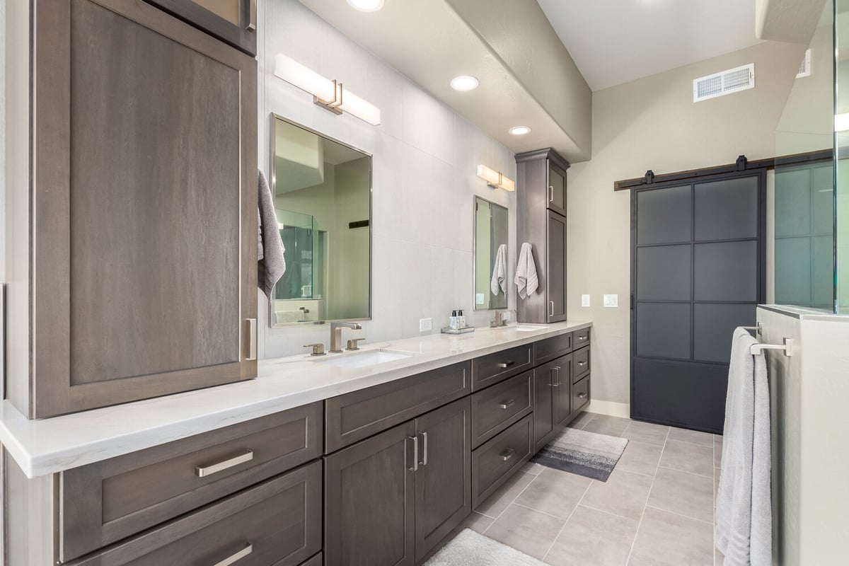 Modern bathroom with long double vanity and dark wood cabinetry in Paradise Valley, AZ by Kitchens by Good Guys.