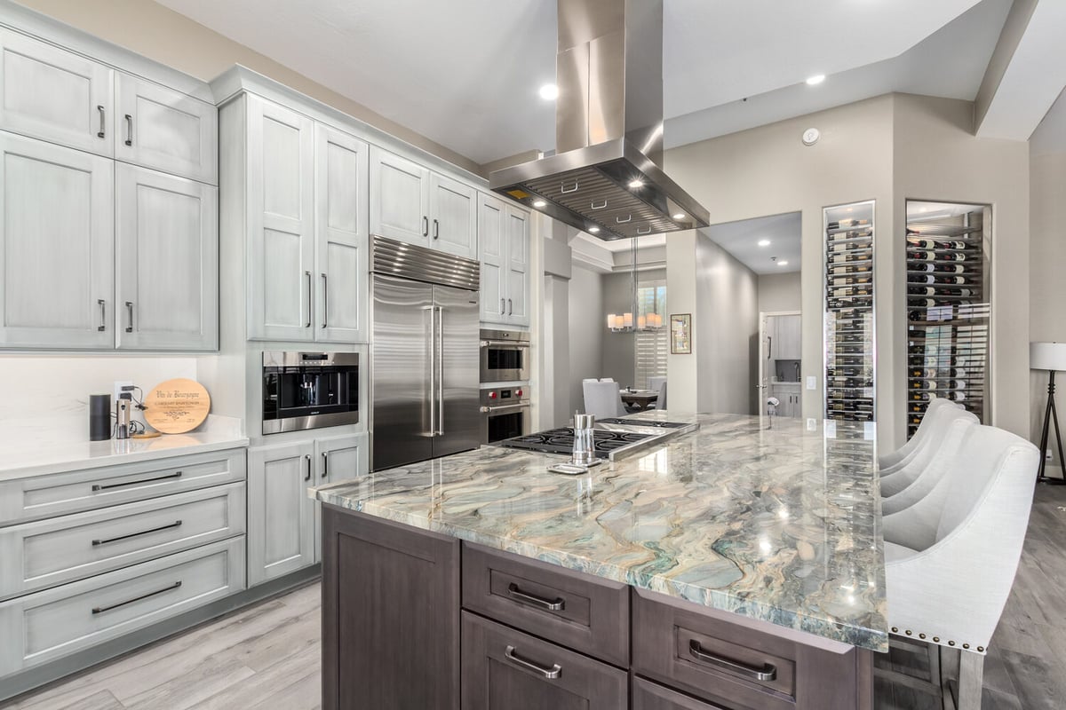 Sleek kitchen with large marble island and full-height cabinetry by Kitchens by Good Guys in Rio Verde, AZ.