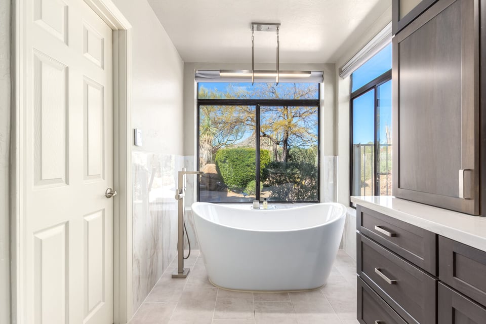 Spa-like bathroom with soaking tub and wall-to-wall windows in custom home by Kitchens by Good Guys in Paradise Valley, AZ.