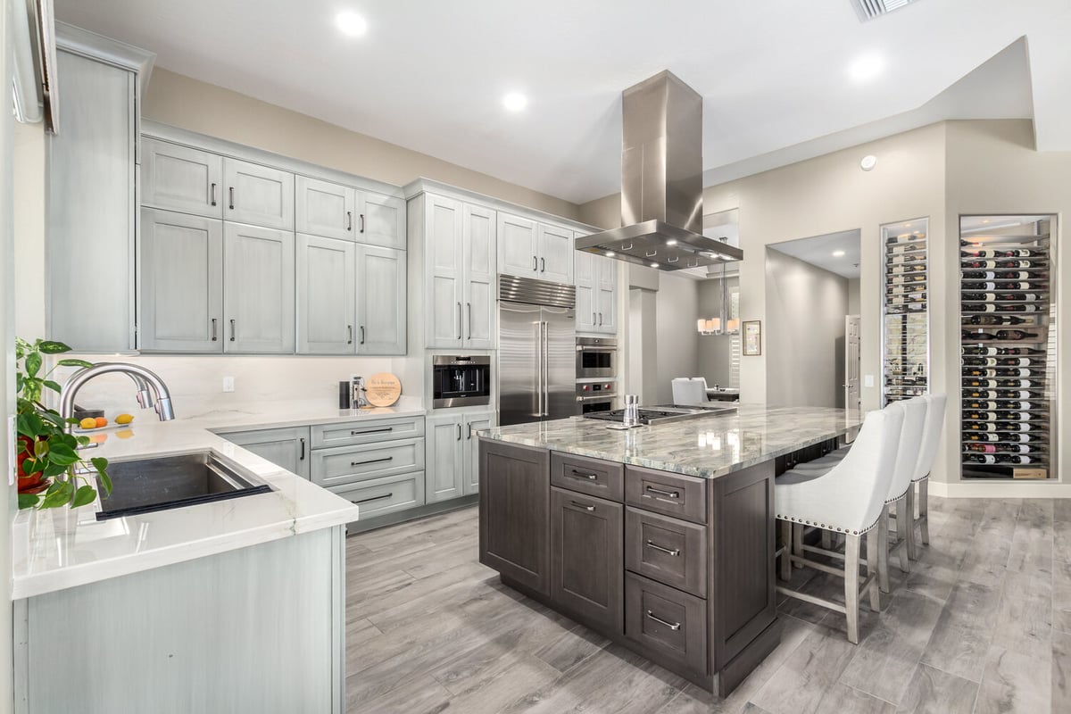 Stylish kitchen layout with breakfast bar and soft gray cabinetry by Kitchens by Good Guys in Paradise Valley, AZ.