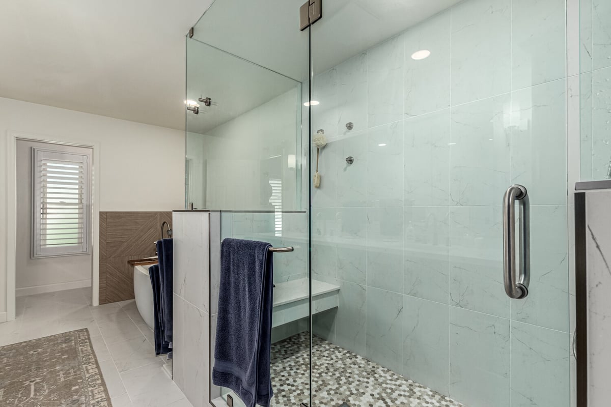 Contemporary bathroom design with marble-style walls and hex floor tile in Scottsdale by Kitchens by Good Guys.