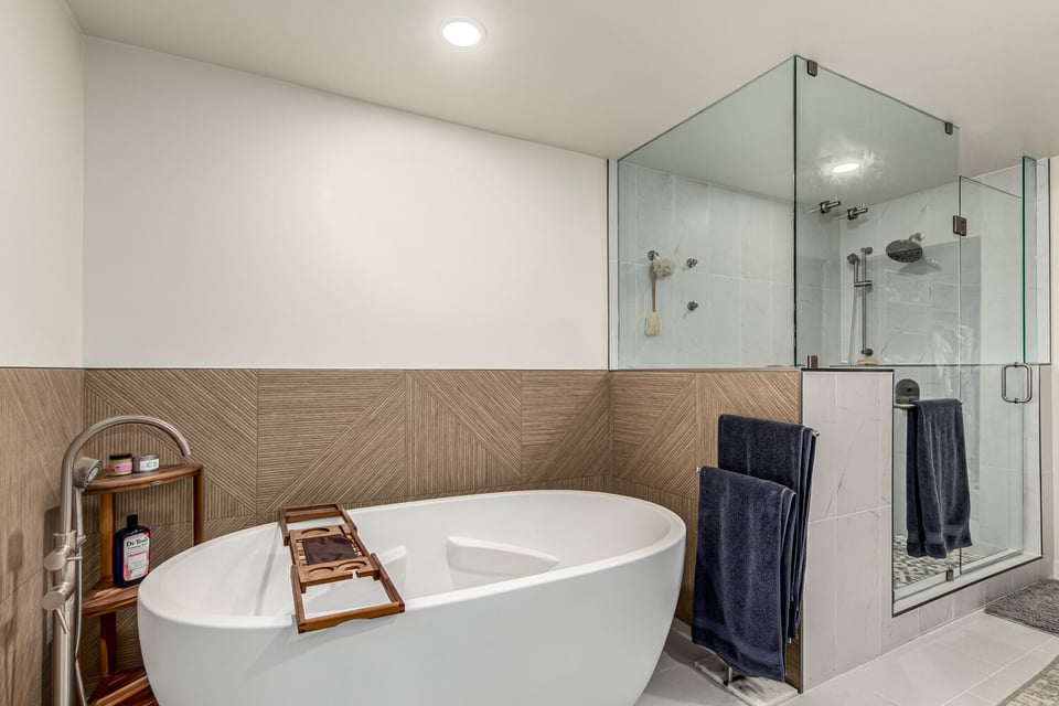 Freestanding soaking tub and glass-enclosed shower in custom Scottsdale bathroom by Kitchens by Good Guys.