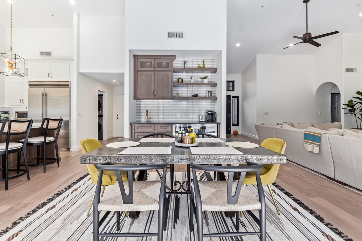 Dining room with built-in bar and view into living room in custom Scottsdale home by Kitchens by Good Guys.