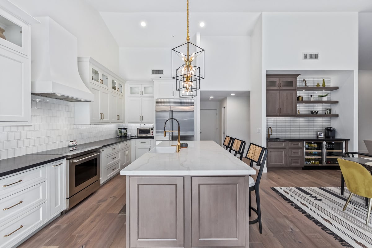 Kitchen island with seating and poolside view in Scottsdale custom home by Kitchens by Good Guys.