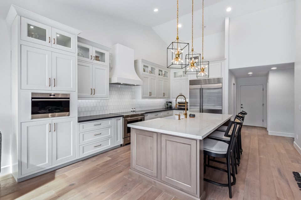 Luxury white kitchen with built-in hood and pendant lights in Scottsdale home by Kitchens by Good Guys.