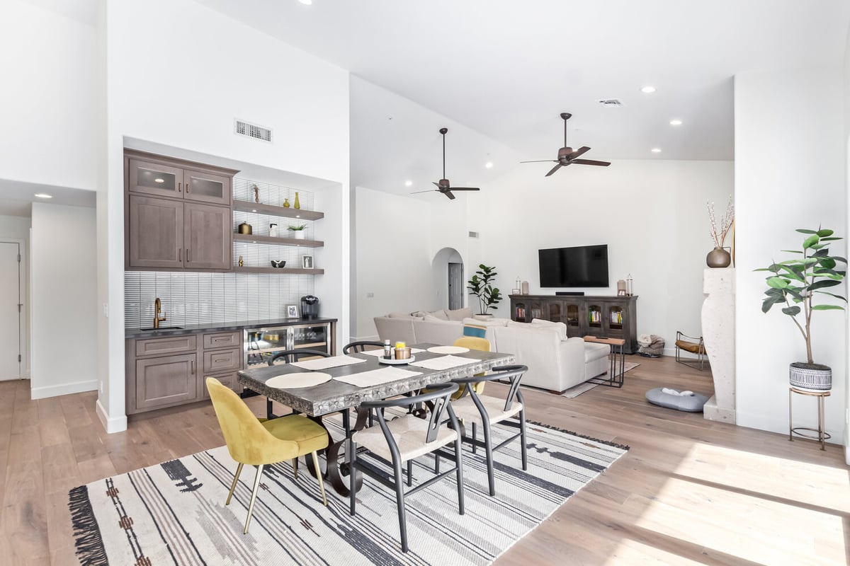 Open-concept dining and living space with natural light in a Scottsdale custom home by Kitchens by Good Guys.