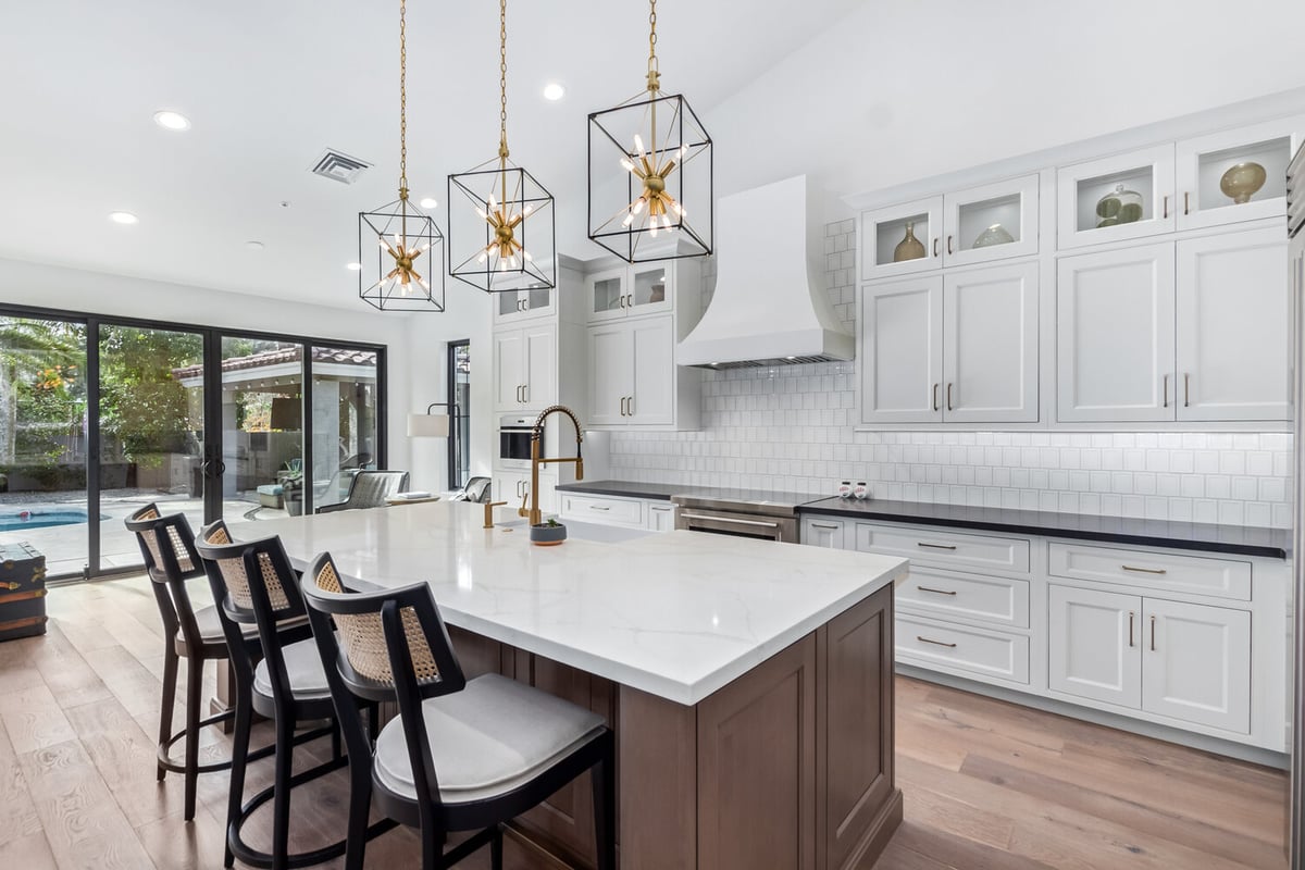 Transitional kitchen design with island seating and white cabinetry in Scottsdale custom home by Kitchens by Good Guys.