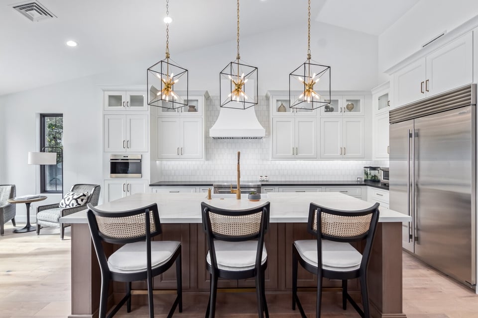 Transitional white kitchen with stainless appliances and island bar in Scottsdale custom home by Kitchens by Good Guys.