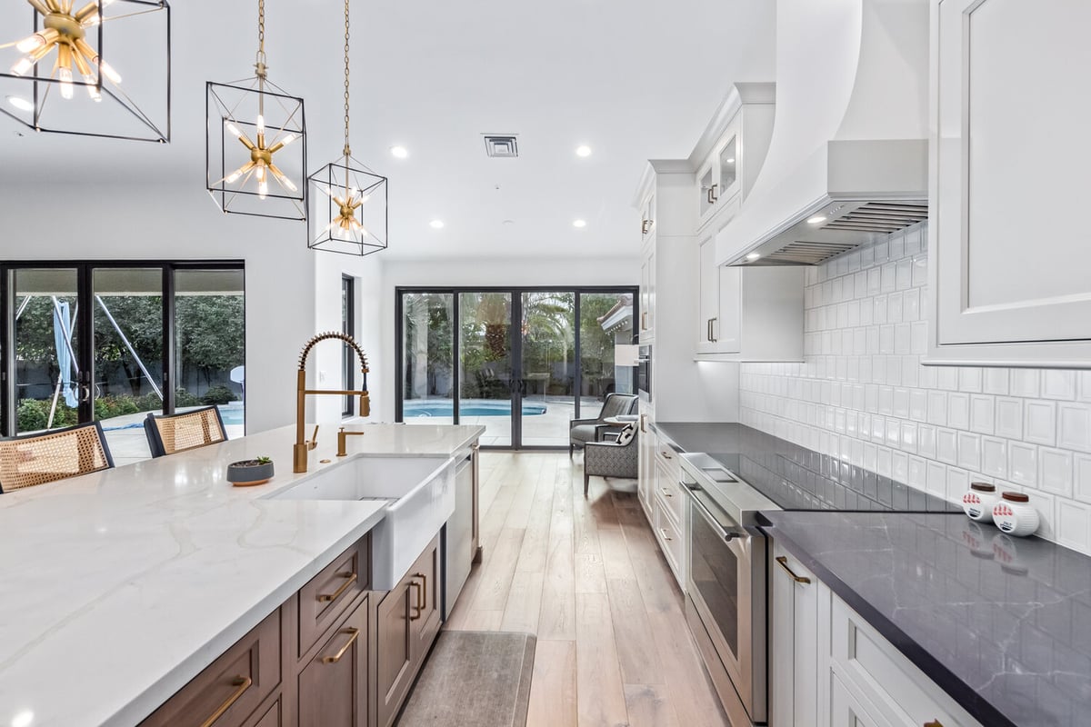 View from kitchen island to backyard with pool in Scottsdale custom home by Kitchens by Good Guys.