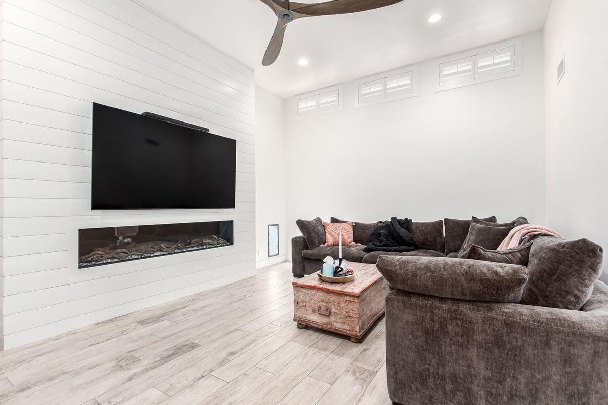 Custom home living room with built-in fireplace and large sectional in Fountain Hills by Kitchens by Good Guys.