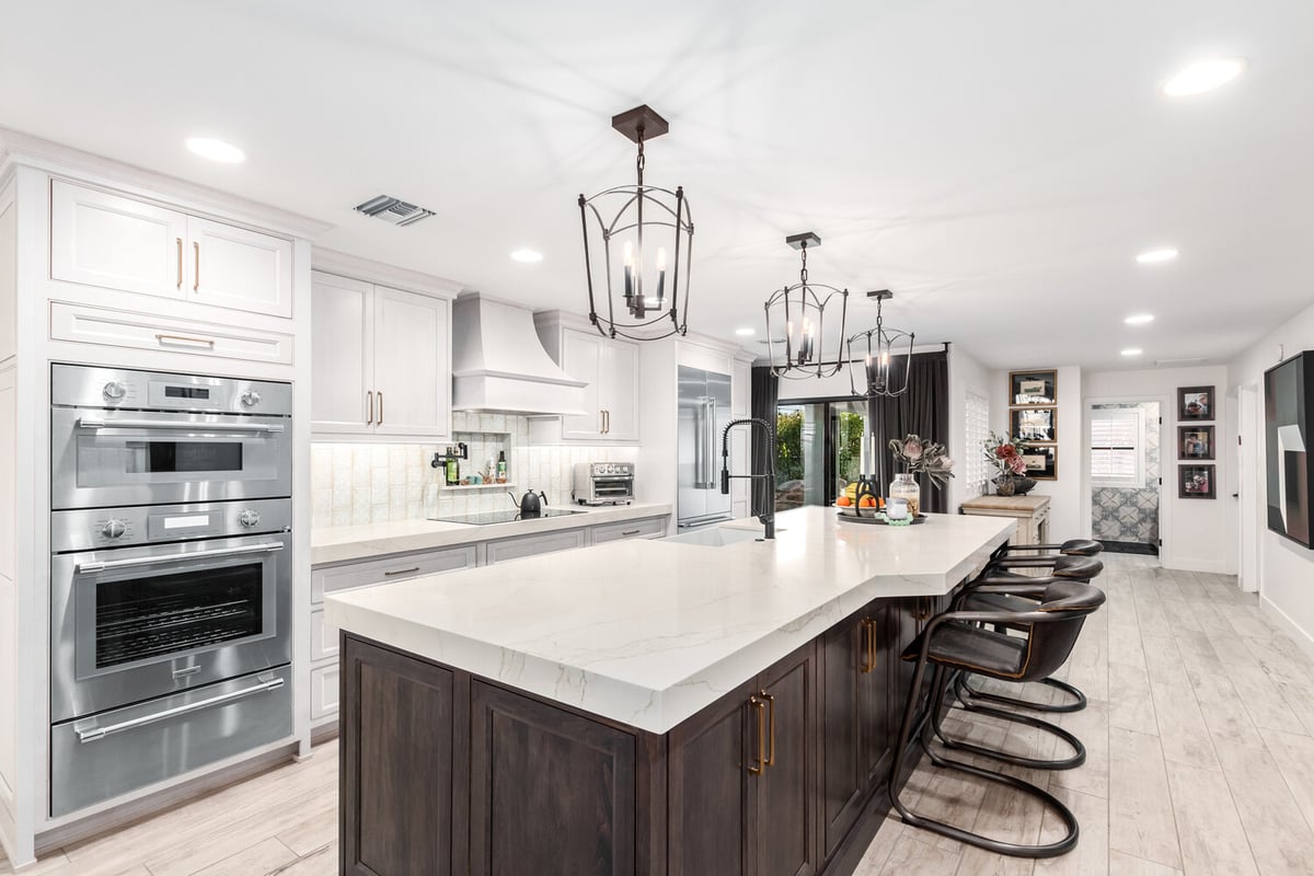 Gourmet kitchen with quartz island and pendant lights in Paradise Valley home by Kitchens by Good Guys.