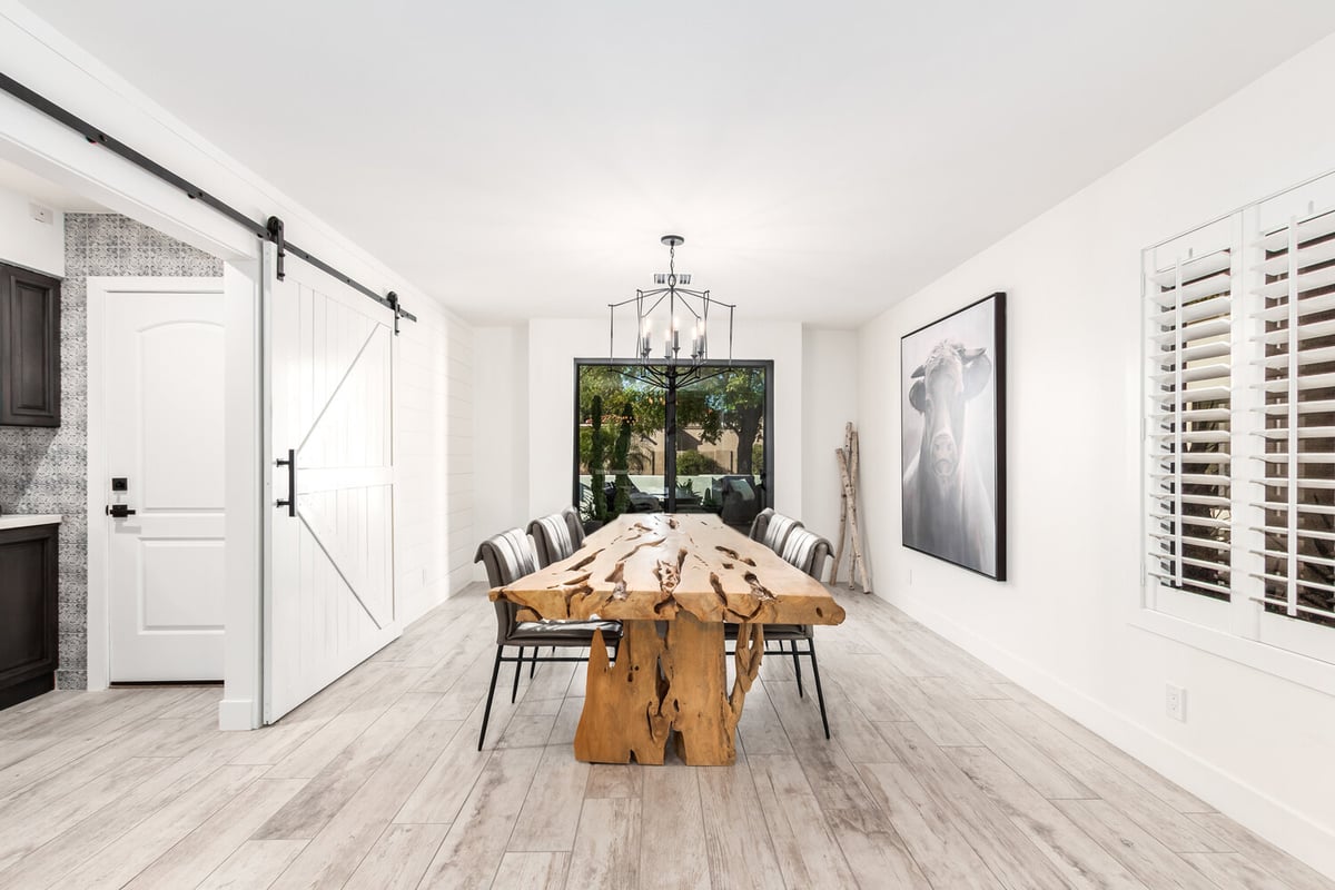 Modern rustic dining room with statement chandelier in Rio Verde custom home by Kitchens by Good Guys.