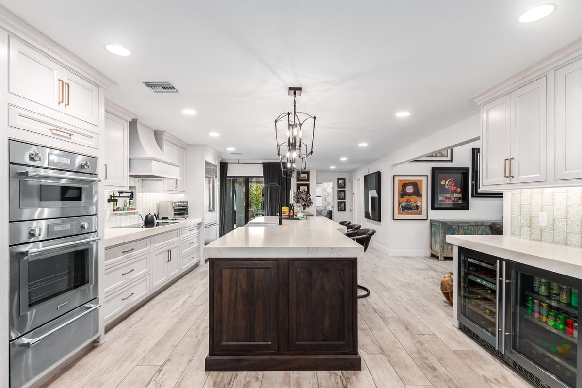 Wide-angle view of luxury kitchen with integrated appliances in Phoenix, AZ by Kitchens by Good Guys.