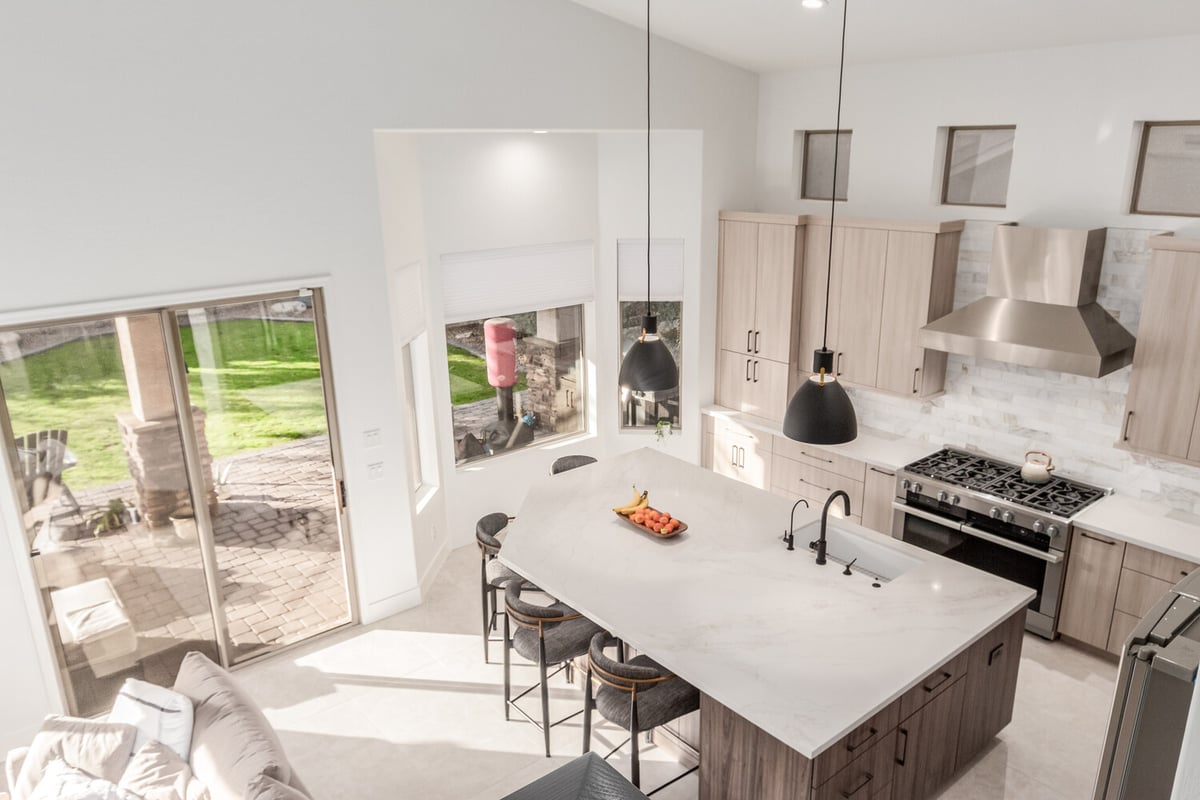 Aerial angle of custom kitchen with pendant lighting and built-in range in Phoenix, AZ by Kitchens by Good Guys.
