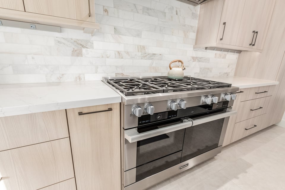 Close-up of Miele range and neutral cabinetry in Scottsdale kitchen by Kitchens by Good Guys.