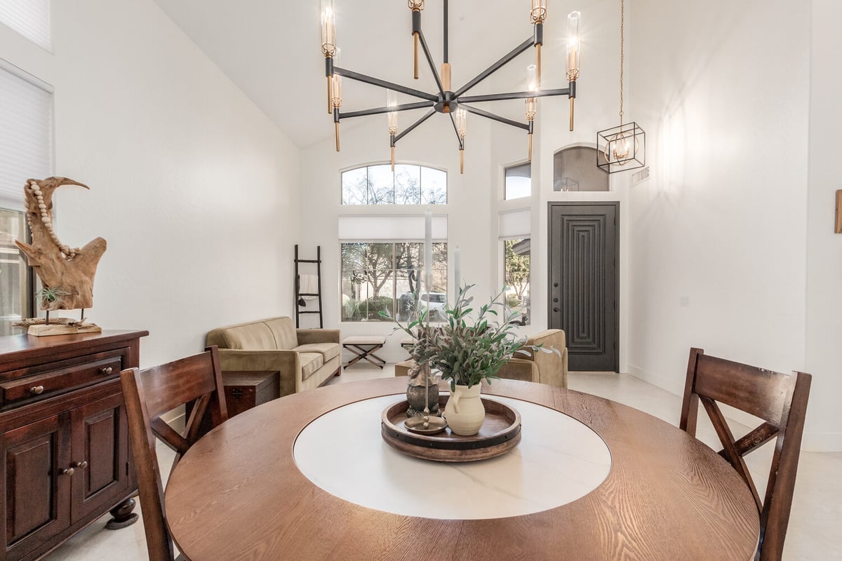 Custom home interior with round dining table and high ceilings in Phoenix by Kitchens by Good Guys.