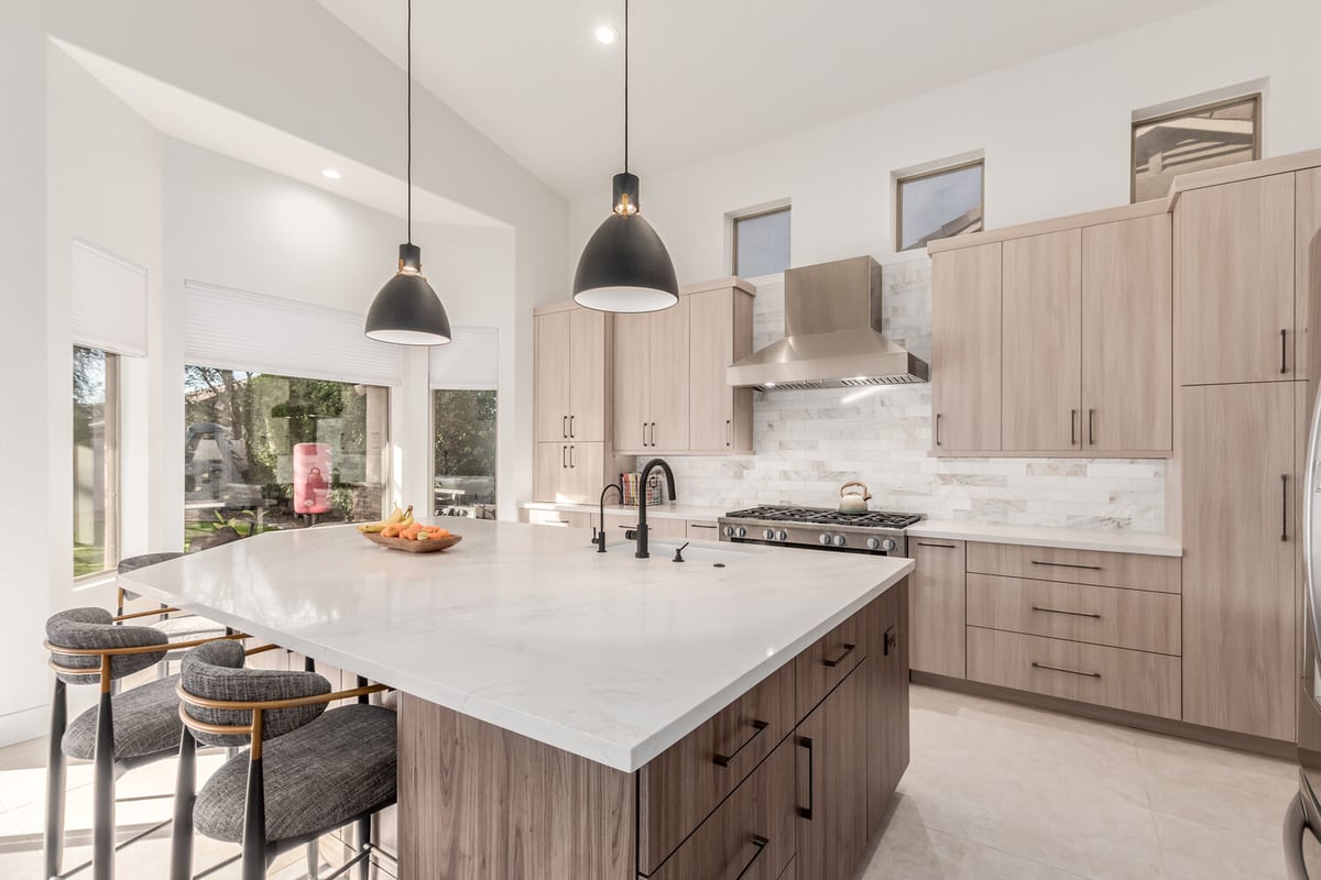 Custom kitchen with wood cabinetry and white island in Paradise Valley, AZ by Kitchens by Good Guys.