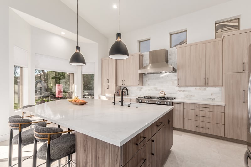 Custom kitchen with wood cabinetry and white island in Paradise Valley, AZ by Kitchens by Good Guys.