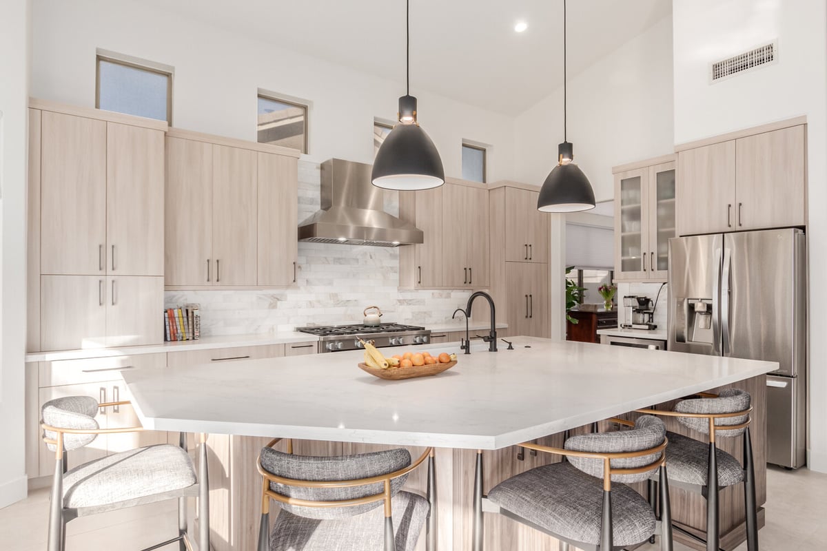 Gourmet kitchen with neutral tones and island seating in Paradise Valley by Kitchens by Good Guys.
