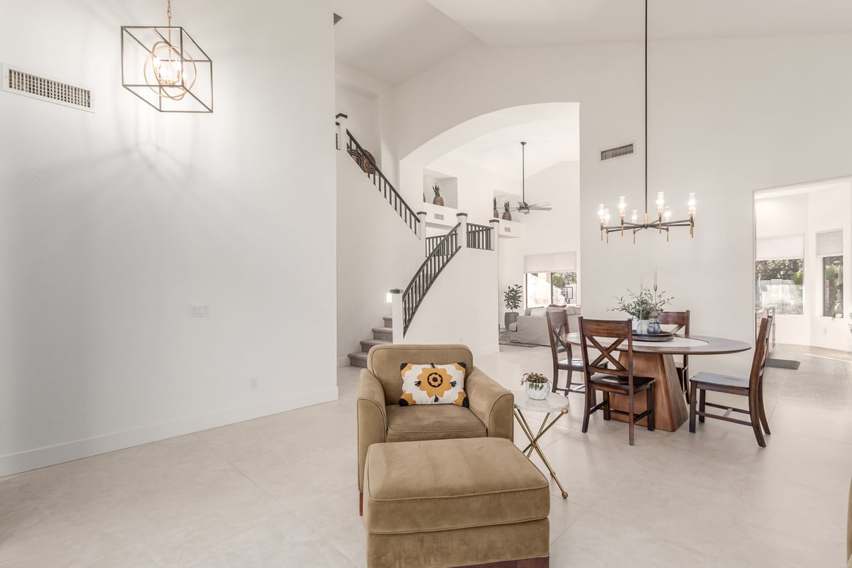 Open-concept layout with dining and staircase view in Fountain Hills, AZ custom home by Kitchens by Good Guys.