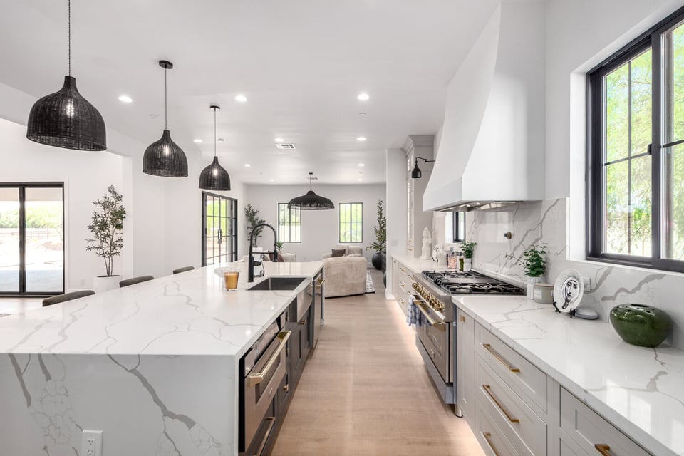 Bright open-concept kitchen flowing into living area in Scottsdale custom home by Kitchens by Good Guys.