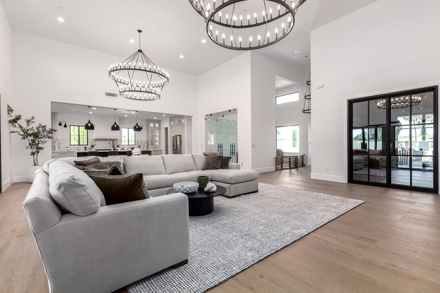 Contemporary custom home living space in Scottsdale by Kitchens by Good Guys featuring high ceilings and large windows