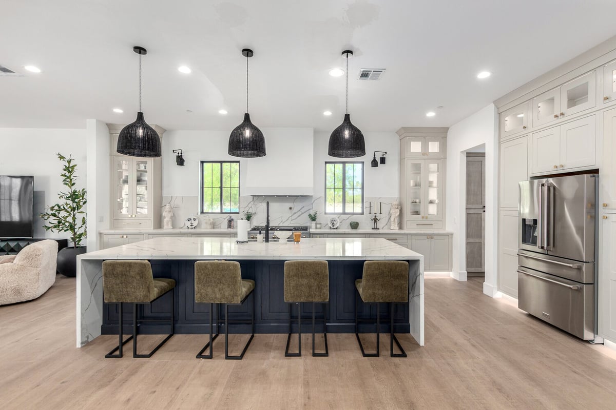 Modern kitchen island with seating and pendant lighting in Scottsdale custom home by Kitchens by Good Guys.