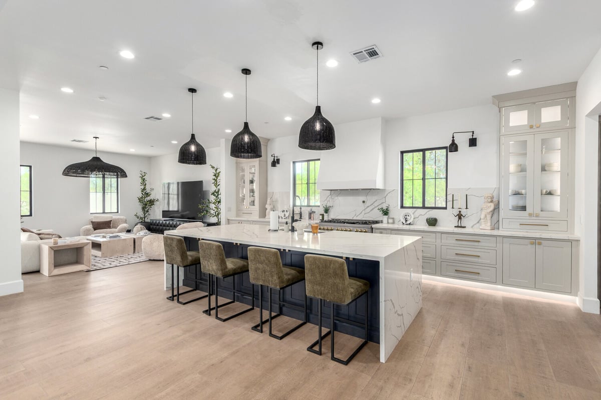 Open kitchen and living layout with center island in Scottsdale custom home by Kitchens by Good Guys.